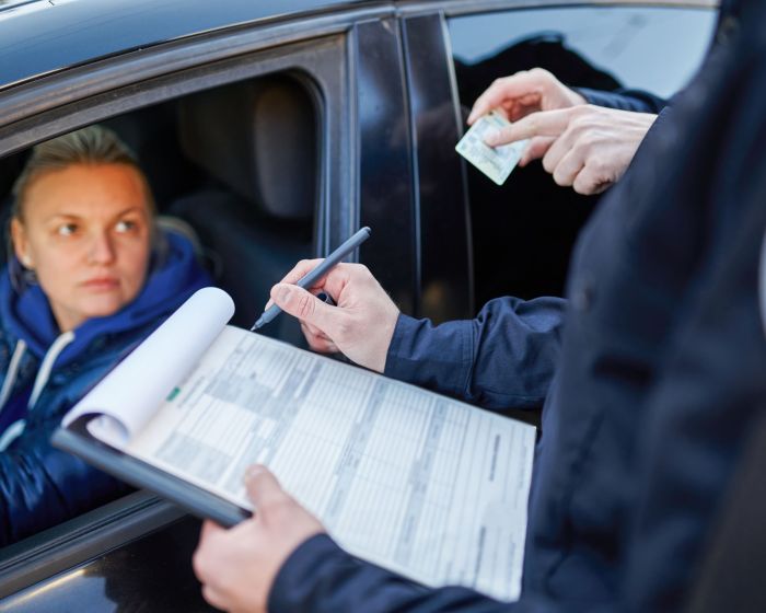 Police patrol checking driver's license of driver